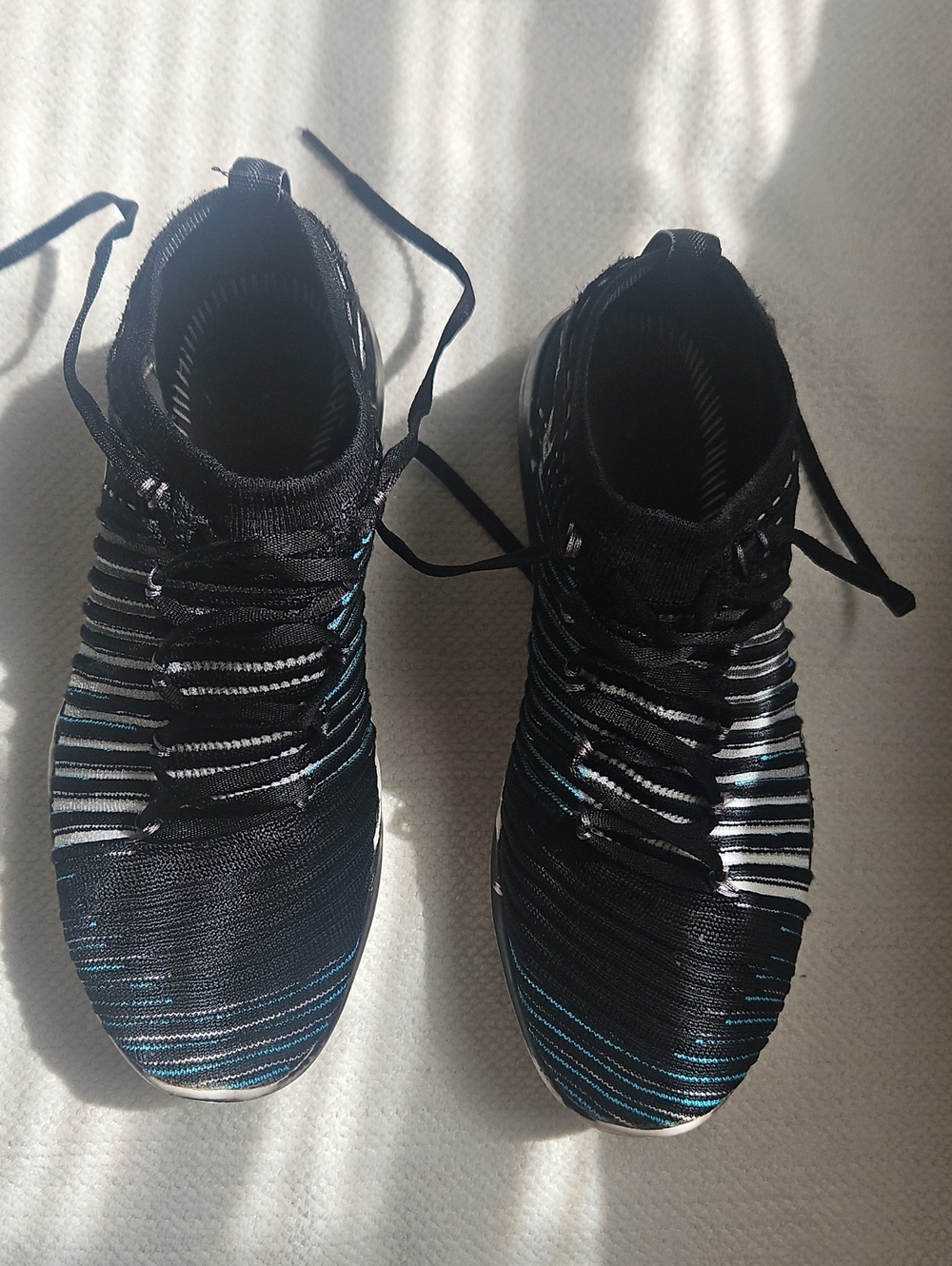 Nike Women's Black Knit Sneakers with Blue and White Stripes